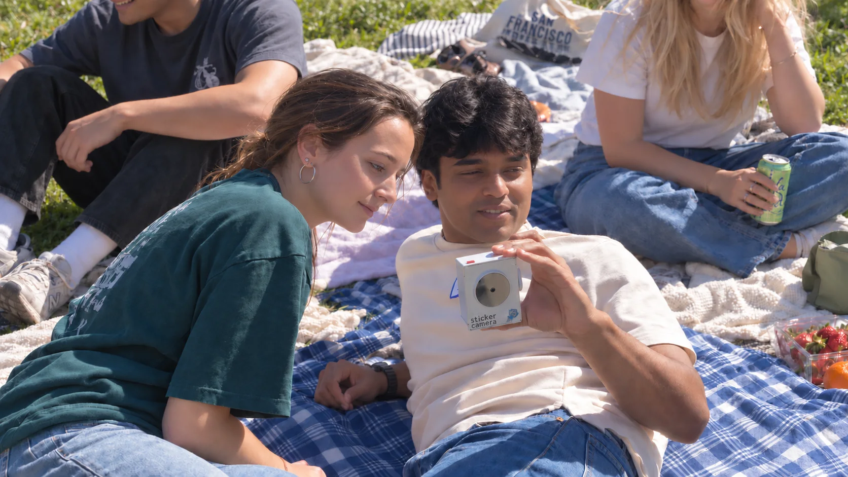 Friends using Sticker Camera together at a picnic